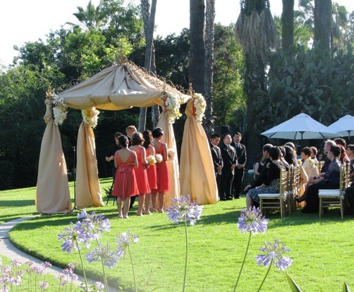 Iron square arch with ivory draping and 4 flower arrangement